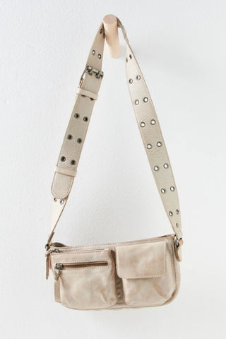 Free People rectangle-shaped leather sling in mineral with wide crossbody strap and zippered compartments.
