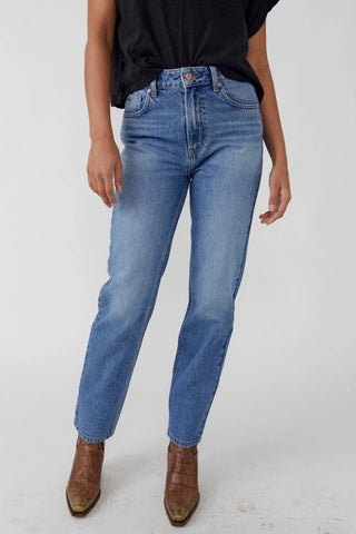 Free People high-rise straight leg jeans in rigid denim with five-pocket design.