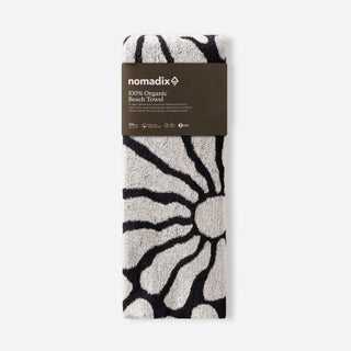 Nomadix Organic Cotton Beach Towel in Lazy Daisy Black — plush, absorbent, Fair Trade Certified™, 100% organic cotton, 30" x 72.5"