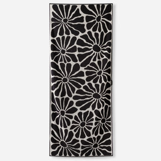 Nomadix Organic Cotton Beach Towel in Lazy Daisy Black — plush, absorbent, Fair Trade Certified™, 100% organic cotton, 30" x 72.5"