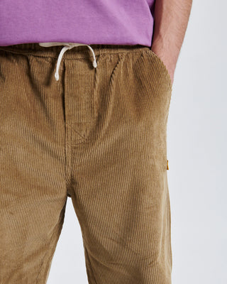 Critical Slide Fever Cord Pant in Camel with relaxed straight fit and elastic waist, made from heavy 8-wale corduroy.