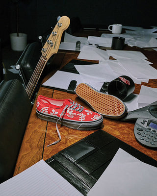 Vans LX Authentic 44 Archive Red sneaker with bright red canvas upper and classic low-top silhouette.
