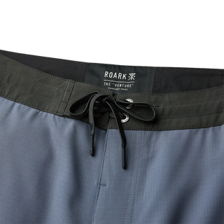 Roark Venture Boardshorts in Neptune, standard fit 90% recycled polyester 10% spandex 4-way stretch ripstop boardshorts with C0 DWR water-resistant finish, 18.5 inch outseam, 8.5 inch inseam, flat-felled seams, and zip front and back pockets