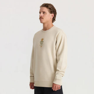 Roark Enjoy Globe Crew sweatshirt in Sand with a small centered flower-and-globe graphic, crew neckline, and ribbed cuffs and hem