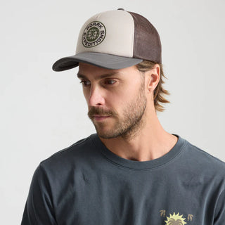 Roark Foam Trucker Global Snapback Hat in Military, structured 5-panel foam front trucker hat in 100% polyester with slightly curved visor, polyester mesh back, snapback closure, contrast visor and mesh color, and satin stitch chain stitch embroidery