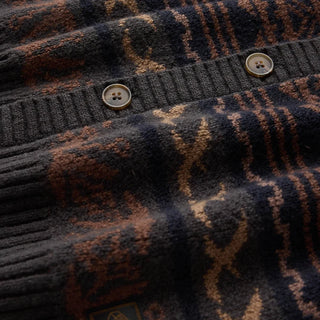 Roark Nomad Cardigan in Rust with horizontal geometric and sun motifs, a V-neck, button-front closure, and dark ribbed trim