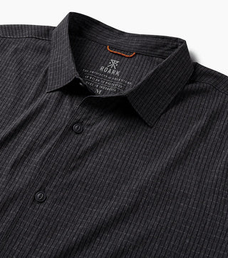 Close-up of black Roark Bless Up Shirt collar, buttons, and textured perforated fabric.