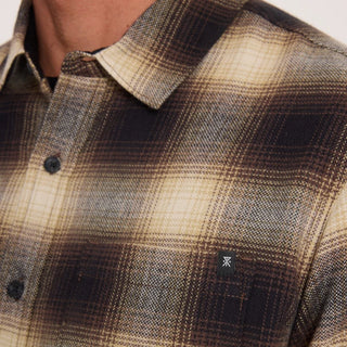 Roark Crossroads Organic Cotton Flannel in Faded Brown with a brown, cream, and grey plaid pattern, button-front closure, chest pocket, and long sleeves