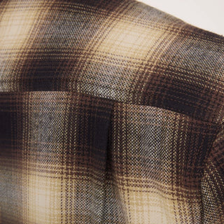 Roark Crossroads Organic Cotton Flannel in Faded Brown with a brown, cream, and grey plaid pattern, button-front closure, chest pocket, and long sleeves