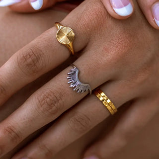 A woman hand showcasing ALCO rings on her fingers