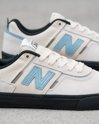 New Balance Numeric Jamie Foy 306 skate shoes in White and Blue with durable suede and mesh upper, rubber underlays, vulcanized outsole, elastic gusseted tongue, and hidden toe protection