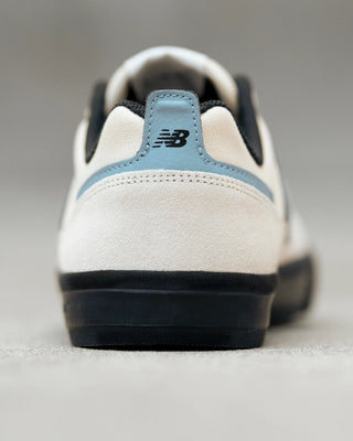 New Balance Numeric Jamie Foy 306 skate shoes in White and Blue with durable suede and mesh upper, rubber underlays, vulcanized outsole, elastic gusseted tongue, and hidden toe protection