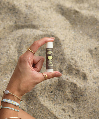 Image of Sun Bum's SPF 30 Sunscreen Lip Balm - Coconut, infused with Aloe and Vitamin E for moisturizing and sun protection.