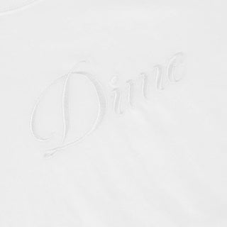 White Dime t-shirt with small cursive embroidered logo on chest and classic short sleeve silhouette.
