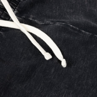 Close-up of black pants with white drawstring