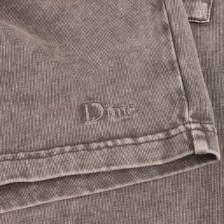 Close-up of a folded gray fabric with a brand logo on it.