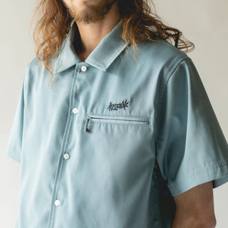 Welcome Skateboards Mace Embroidered Twill Work Shirt in Slate, featuring a relaxed fit, metal zip left chest pocket with a ball/chain pull, vampire logo embroidery at the left chest, and mace graphic back embroidery.