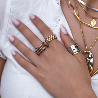Mixed-metal statement ring with bold sculpted design.