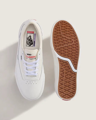 White sneaker with brown sole on a light gray background