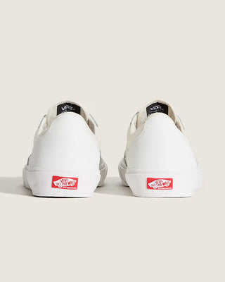 White sneakers with red labels on a light gray background