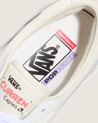Close-up of a Vans sneaker with a focus on the brand logo and text.
