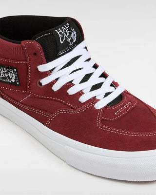 Red sneaker with white laces and a visible brand logo on a white background