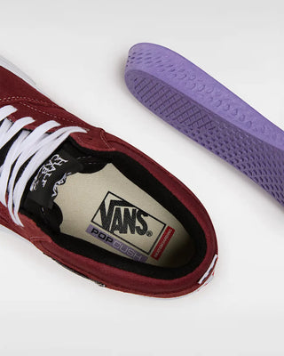Maroon Vans sneaker with purple sole on a white background