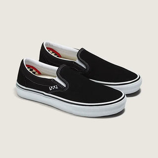Black slip-on sneakers with white soles on a light gray background