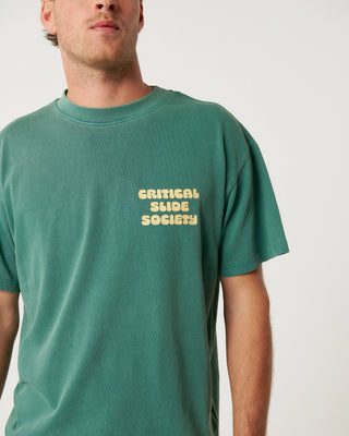 Critical Slide Sabbatical Tee in Dusty Green with artist collaboration print and garment-dyed soft cotton finish.