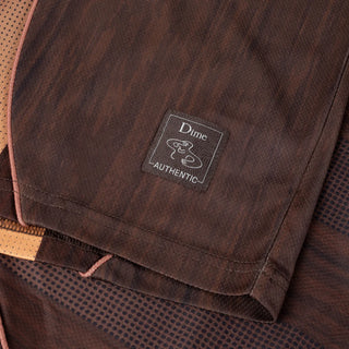 Bronze Dime team jersey with woodgrain pattern, gradient striping, and raglan sleeve athletic silhouette.
