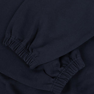 Close-up of dark blue pants with a focus on the waistband.