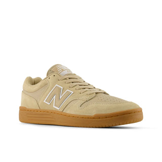 Beige sneaker with brown sole on a white background
