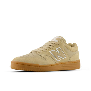Beige sneaker with brown sole on a white background