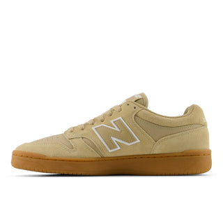 Beige sneaker with a white 'N' logo on a white background