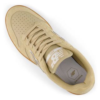 Beige sneaker with brown sole on a white background