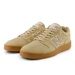 Beige sneakers with brown soles on a white background