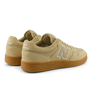 Beige sneakers with brown soles on a white background
