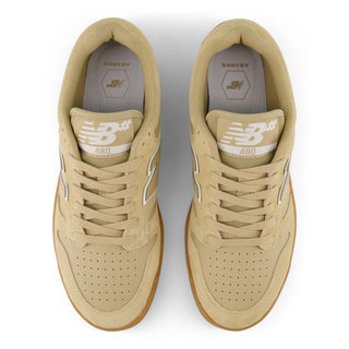 Pair of tan sneakers with New Balance logo on a white background