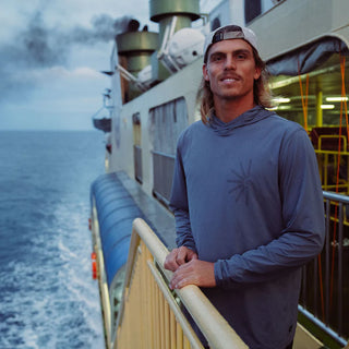 Roark Men's Venture LS UPF Hoodie in Neptune — lightweight GRS-certified recycled polyester with UPF 50+ protection and sleeve thumb holes for water and trail use