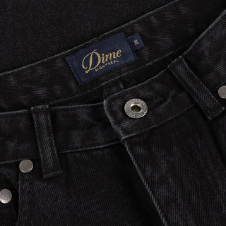 Front view of Dime Women’s Baggy Denim Pants in Black with wide legs, curved front pockets, a coin pocket, and belt loops
