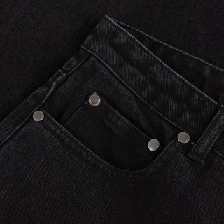 Front view of Dime Women’s Baggy Denim Pants in Black with wide legs, curved front pockets, a coin pocket, and belt loops