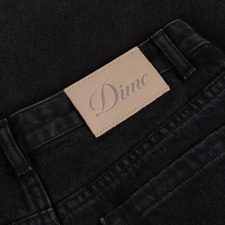 Front view of Dime Women’s Baggy Denim Pants in Black with wide legs, curved front pockets, a coin pocket, and belt loops