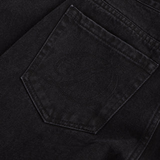 Front view of Dime Women’s Baggy Denim Pants in Black with wide legs, curved front pockets, a coin pocket, and belt loops