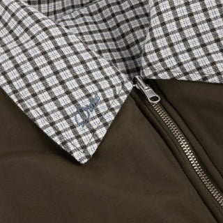 Front view of Dime Reversible Bomber Jacket in Olive with a contrasting plaid collar, full-length zipper, raglan sleeves, and gathered cuffs and hem