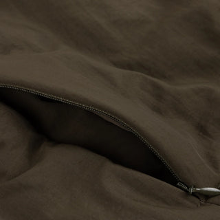 Front view of Dime Reversible Bomber Jacket in Olive with a contrasting plaid collar, full-length zipper, raglan sleeves, and gathered cuffs and hem