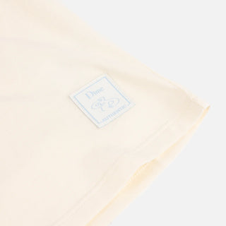 Front view of Dime Women’s Team Tee in Off-White with a large pale number 50 graphic across the chest and a small label near the hem