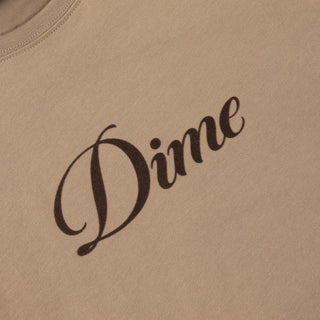 White Dime t-shirt with cursive flocked logo graphic on front and classic short sleeve silhouette.
