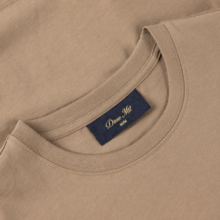 White Dime t-shirt with cursive flocked logo graphic on front and classic short sleeve silhouette.
