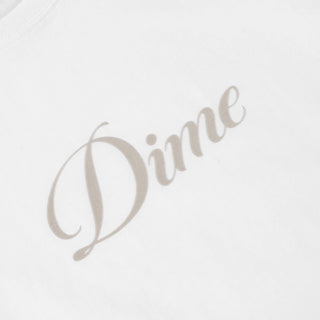 White Dime t-shirt with cursive flocked logo graphic on front and classic short sleeve silhouette.
