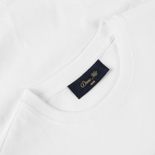 White Dime t-shirt with cursive flocked logo graphic on front and classic short sleeve silhouette.
